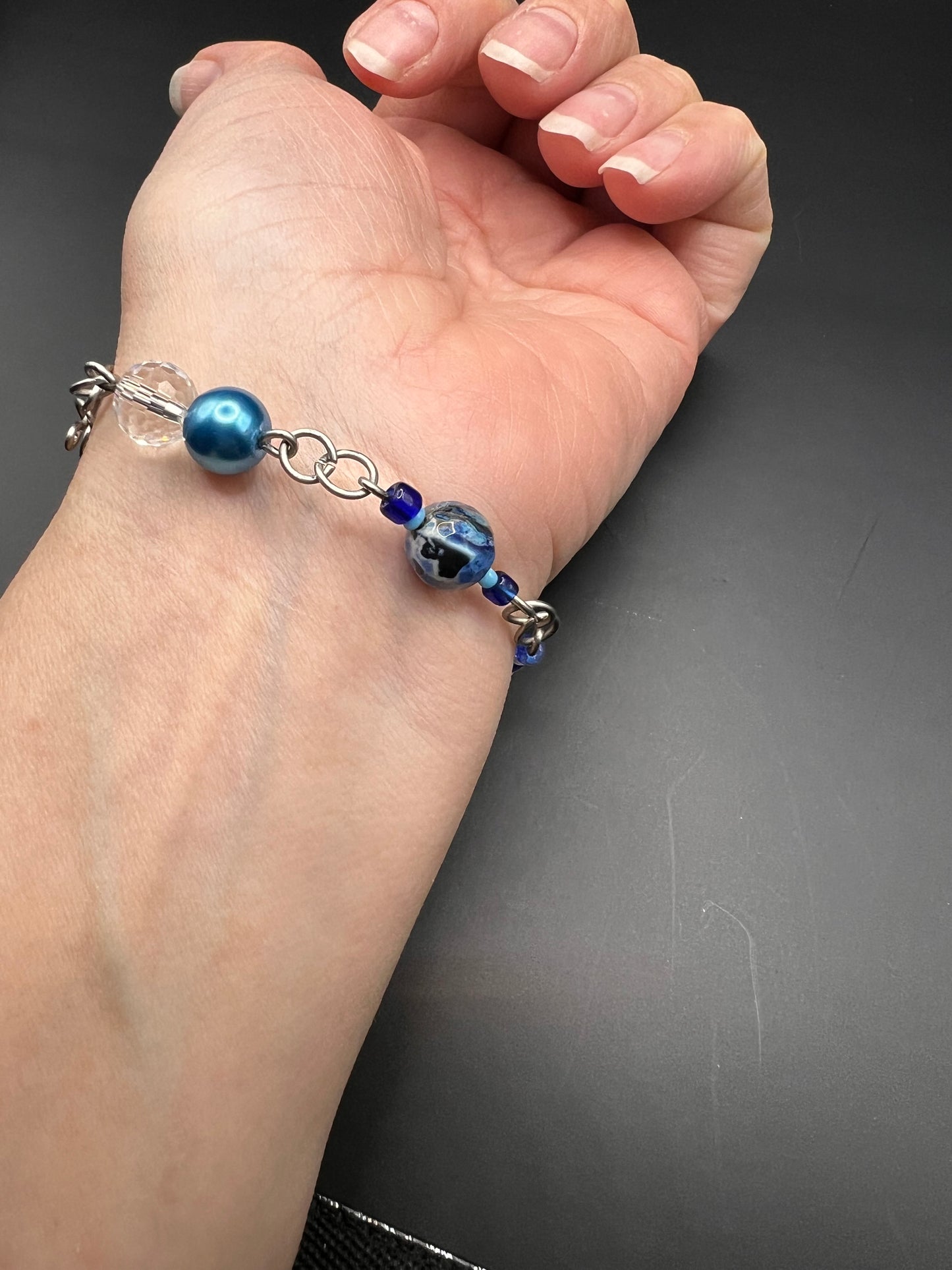 Silver bracelet with variety of sizes and colors of blue beads