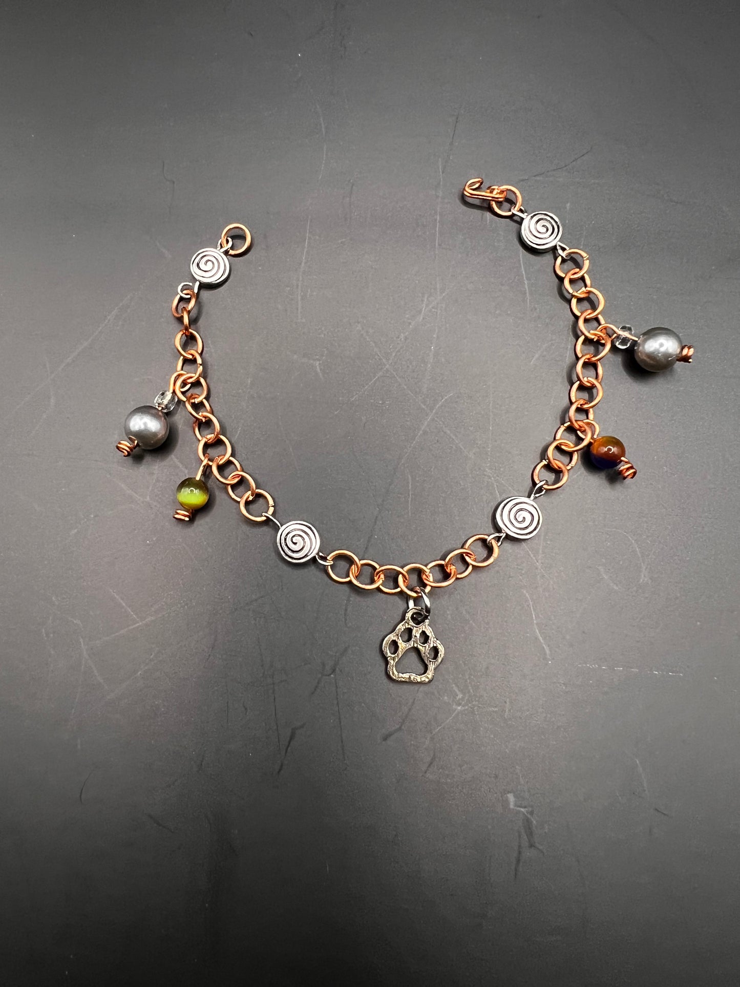 Copper bracelet w/ charms, paw print & swirl beads