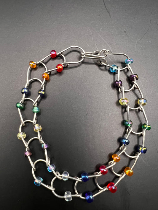 Silver bracelet with horseshoe shaped links with multicolored beads