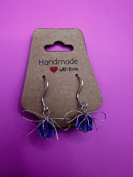 Silver dangly handmade earrings with blue presents
