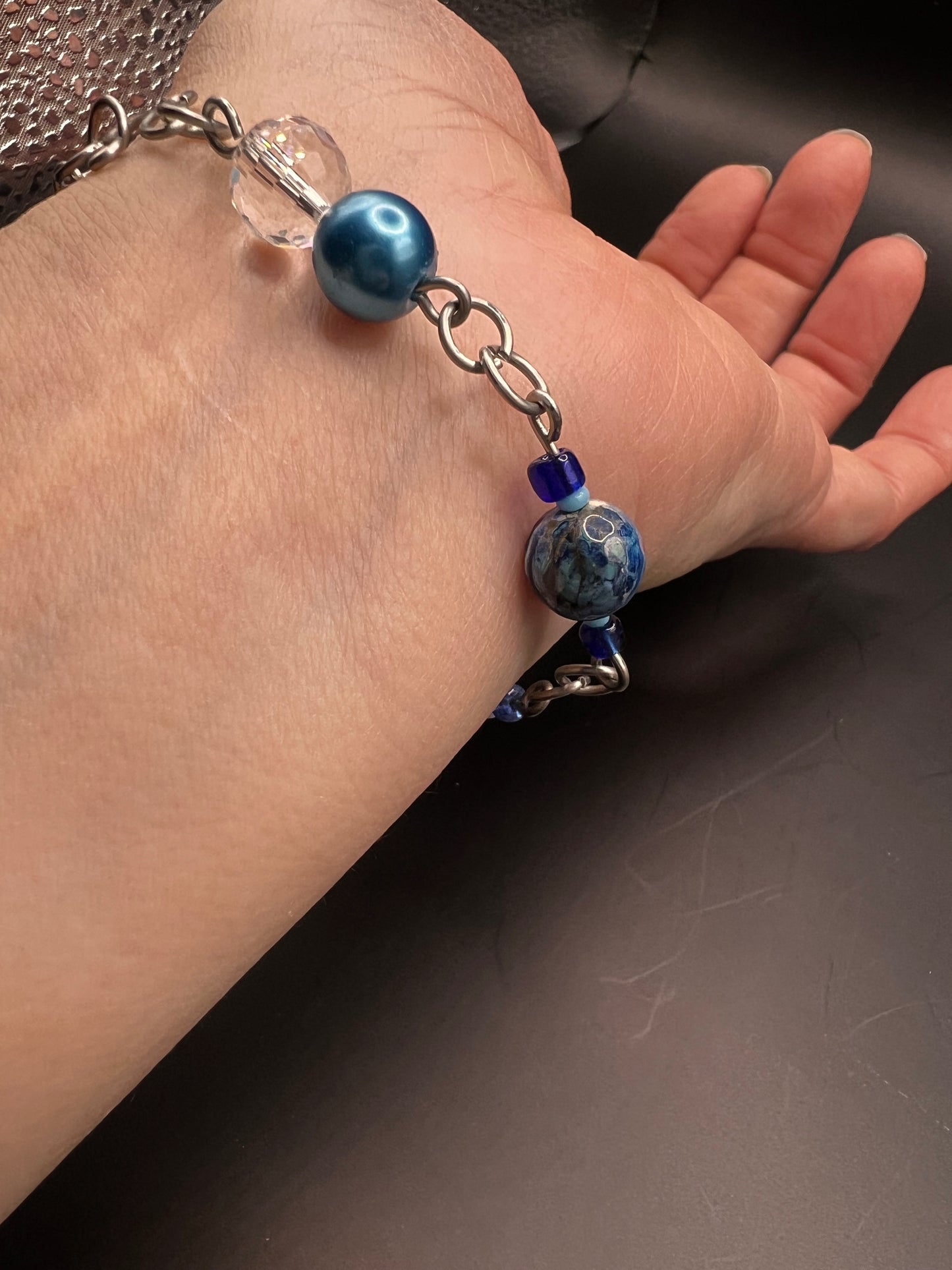 Silver bracelet with variety of sizes and colors of blue beads