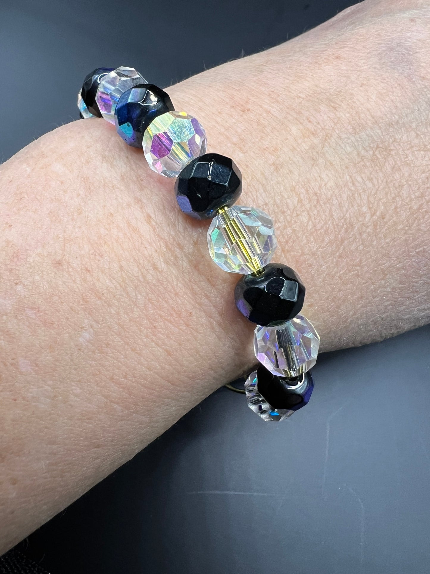Gold cuff bracelet with multicolored beads which are also iridescent & turtle embellishment.