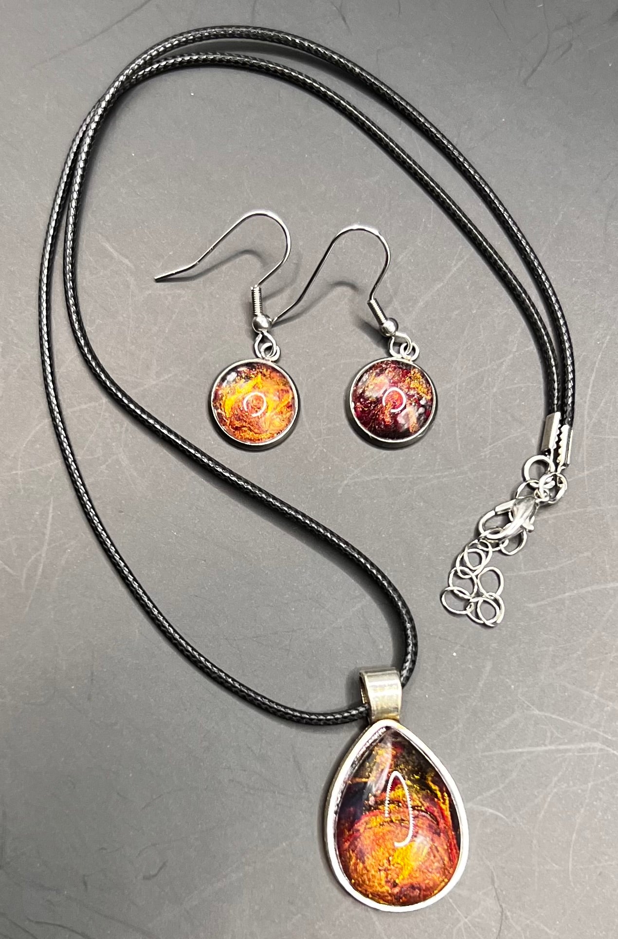 Fiery colors teardrop silver cabochon necklace with black chord