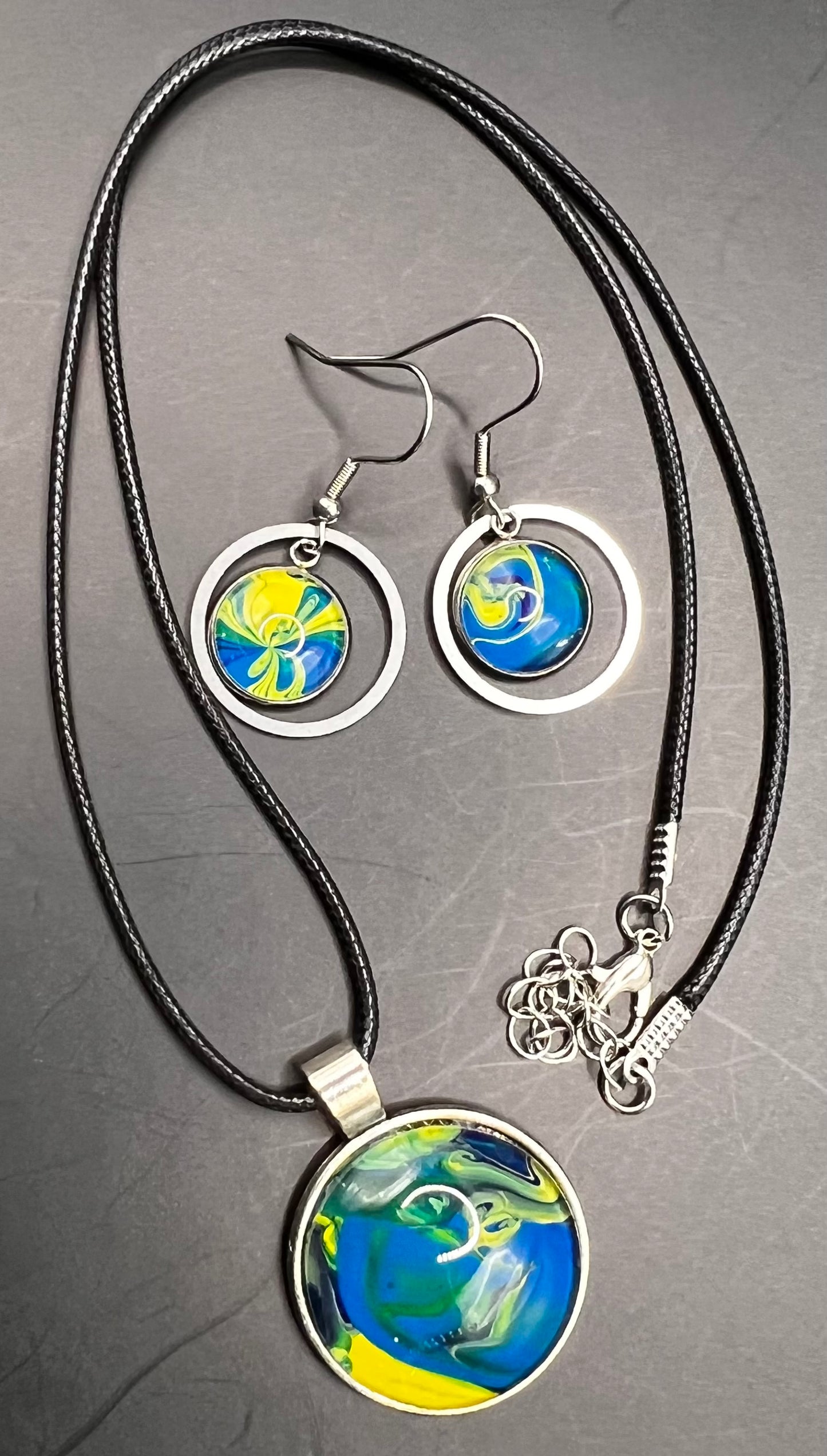 Blue & yellow round & outline circle silver cabochon W/ black chord