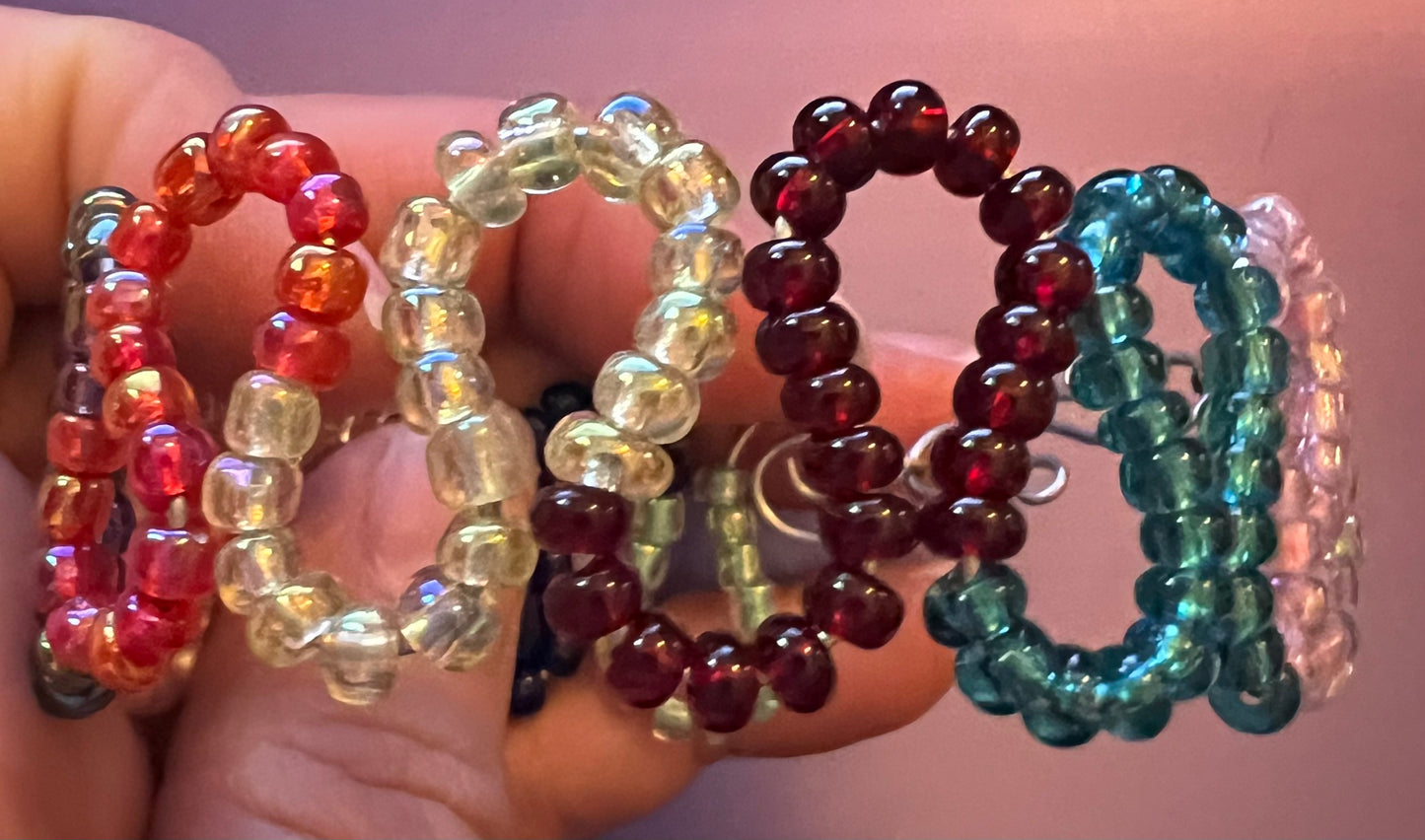 Multicolored loops w/ seed beads & coils. Cuffed silver bracelet