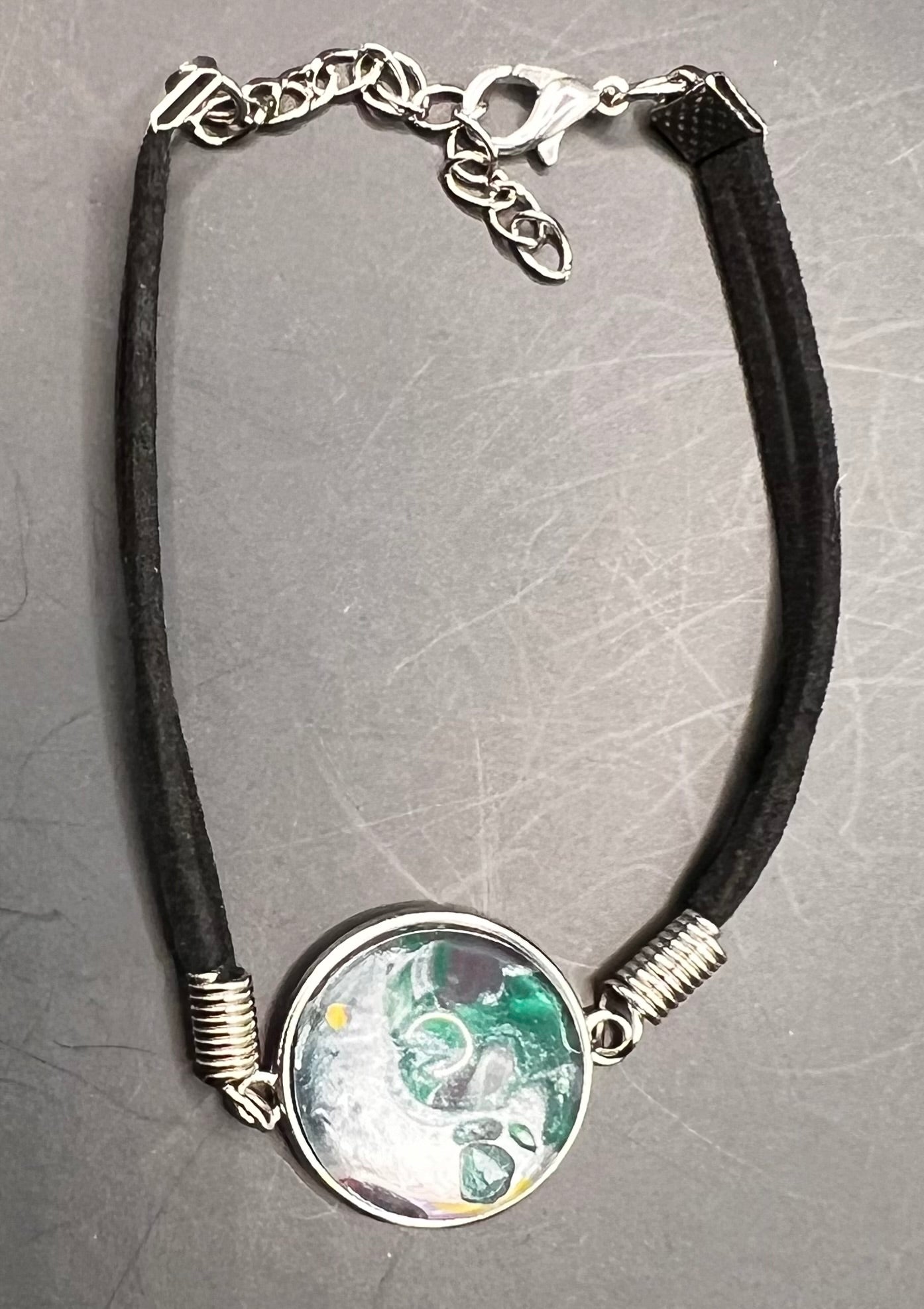 Green, silver, yellow & pink round cabochon bracelet with black chord