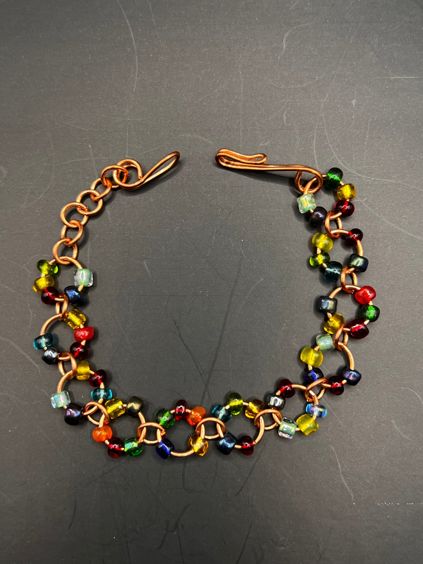 Copper bracelet with loops and multicolored seed beads