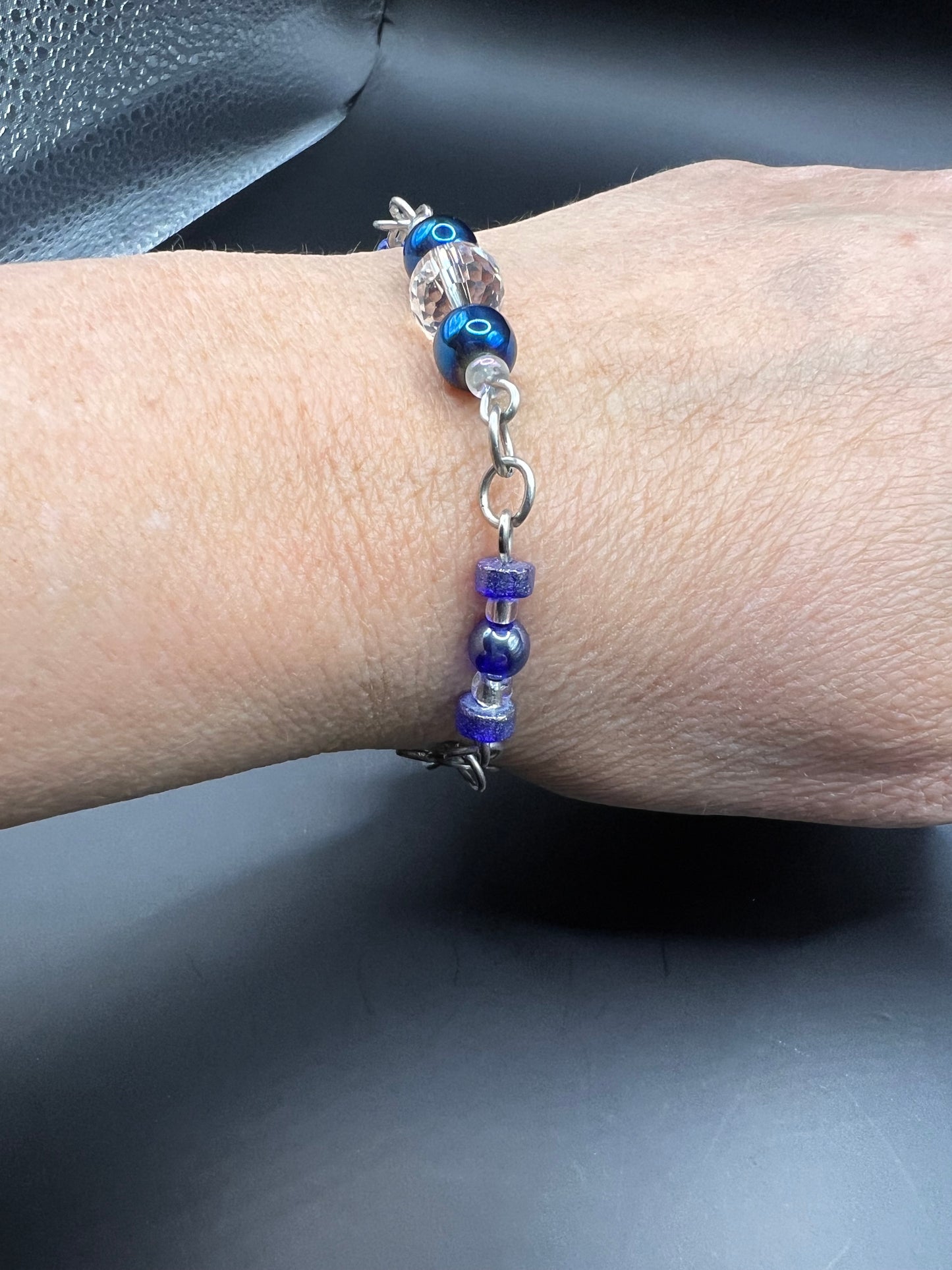 Silver bracelet with variety of sizes and colors of blue beads