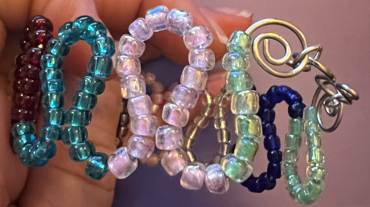 Multicolored loops w/ seed beads & coils. Cuffed silver bracelet