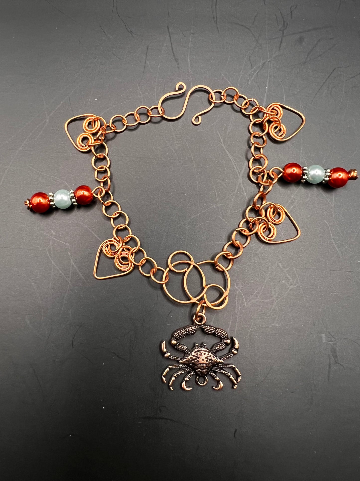 Copper bracelet w/ coiled hearts and multicolored beads & crab embellishment