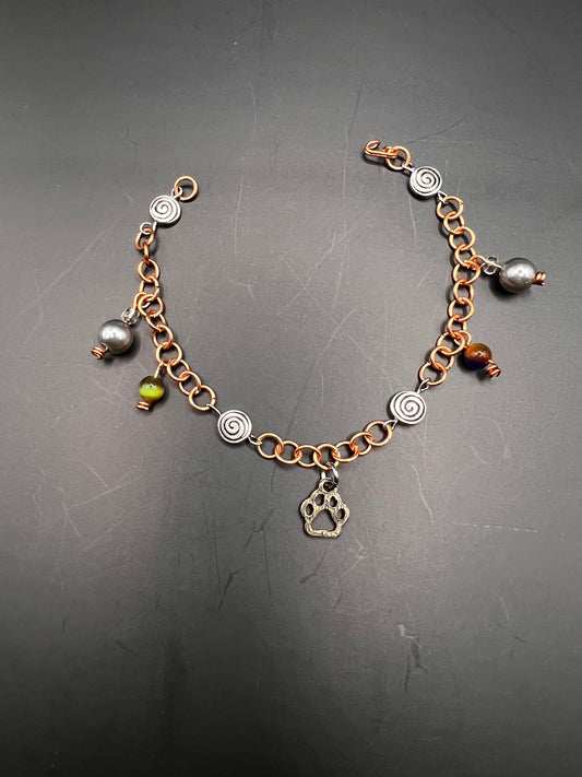 Copper bracelet w/ charms, paw print & swirl beads